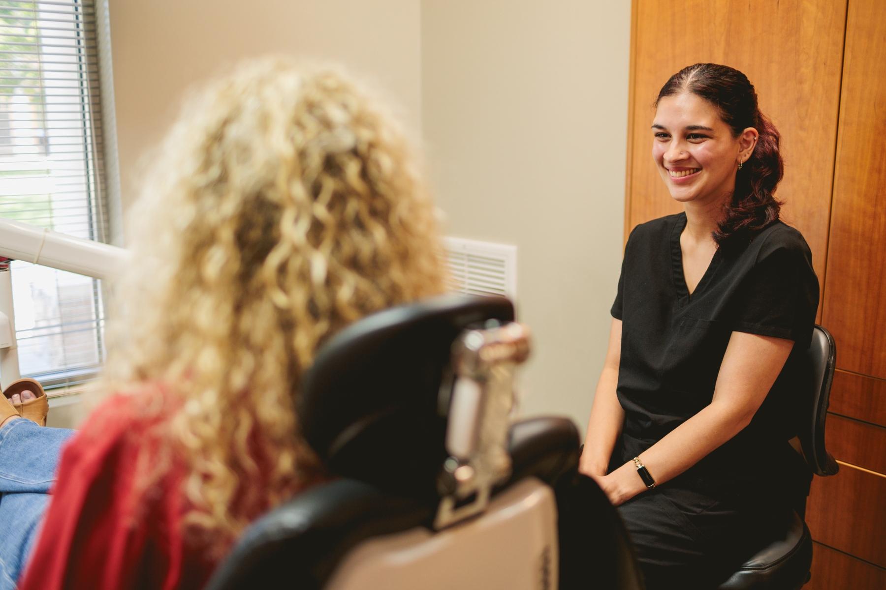Dental hygienist talking to patient